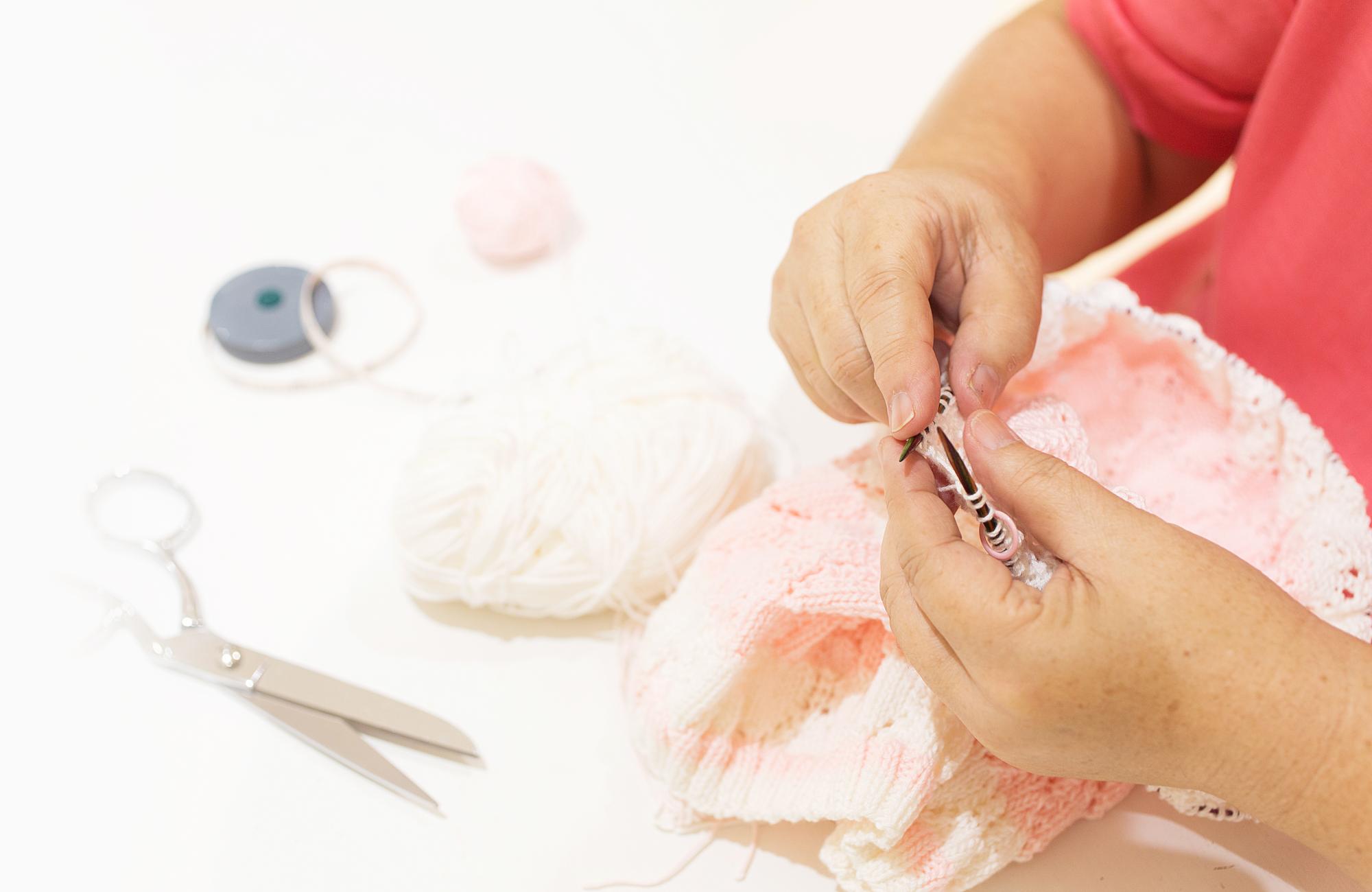 Instructor demonstrating satin stitch to a student in the studio